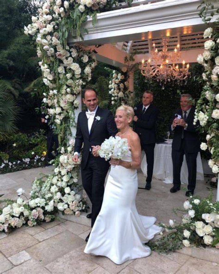 Roberta Raffel in her wedding gown clicks a selfie with husband Marcus Lemonis.